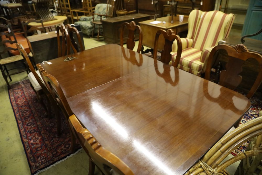 A reproduction mahogany twin pillar extending dining table and eight George I style chairs, 300cm extended (two spare leaves)
